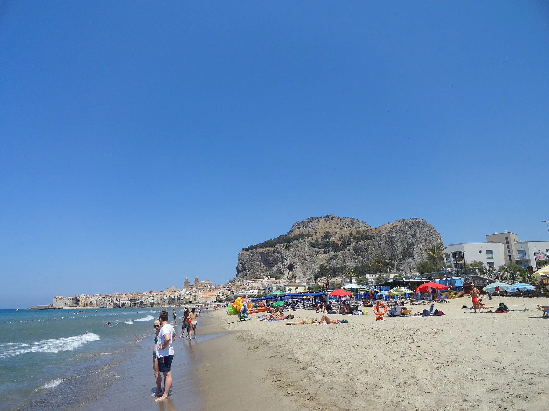 Cefalù beach, waterfront buildings and the rocky headland